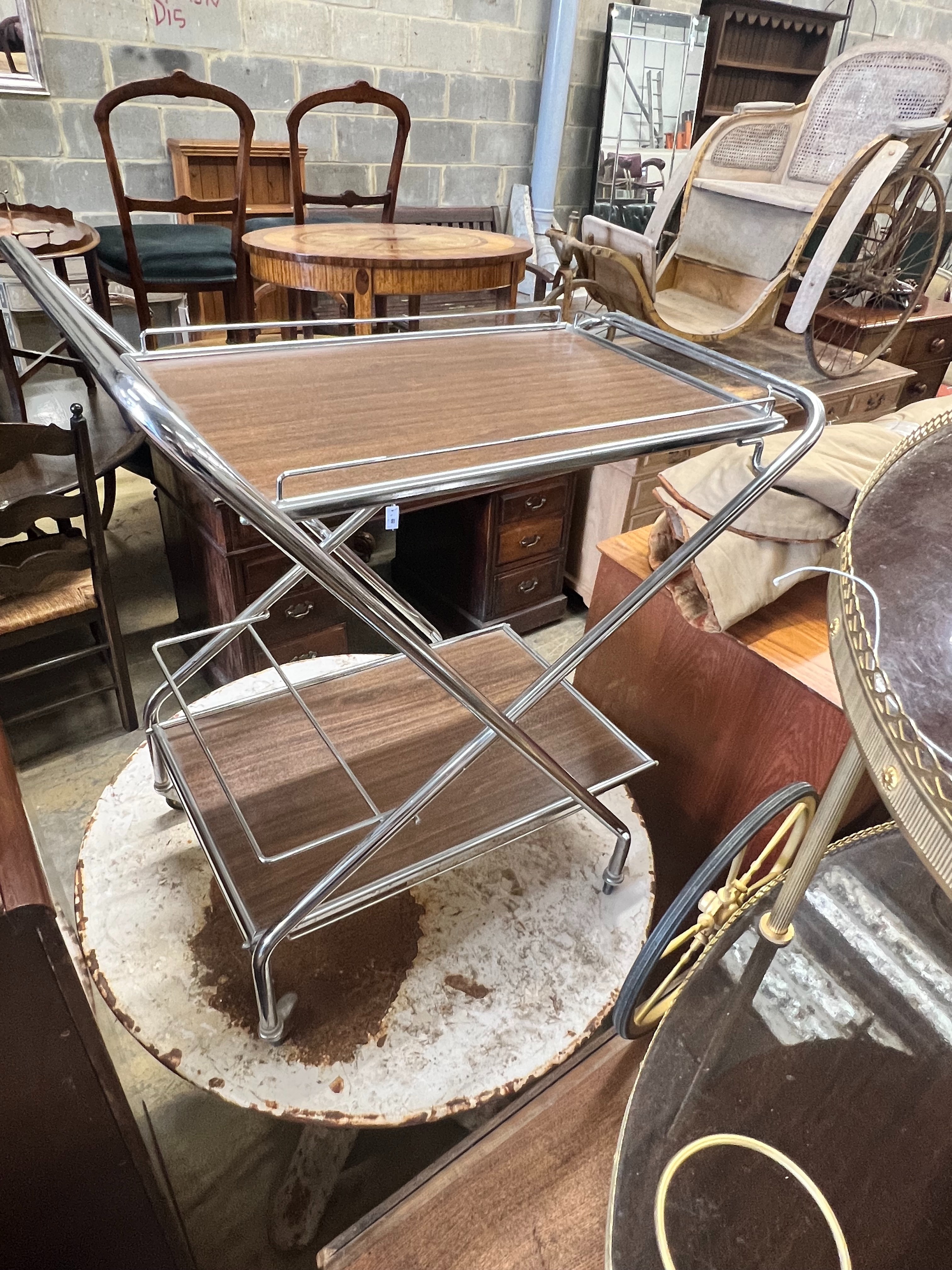 An oval gilt metal tea trolley, height 79cm, together with a smaller chrome folding tea trolley